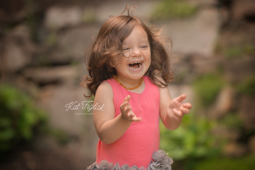 Laughing little girl in pink dress