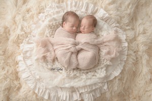 newborn twin girls wrapped together