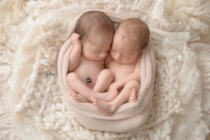 newborn twin girls wrapped up together
