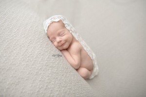 smiling newborn baby girl with lace