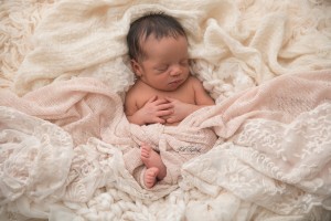 Newborn baby girl in pink wrap