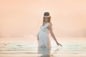 pregnant mom in lake with sunset