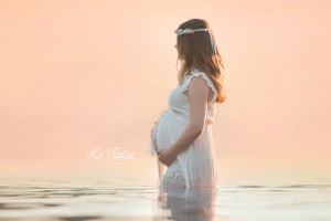 Pregnant mom in lake with beautiful sunset