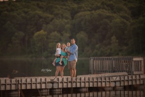 family of four standing on dock