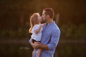 little girl kissing her daddy