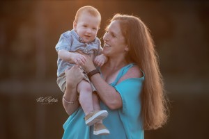 mom laughing and holding smiling son