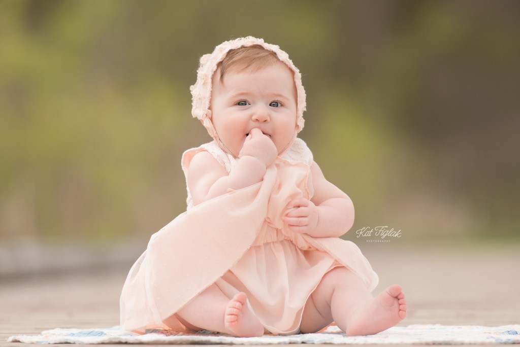cheeky baby girl holding her dress