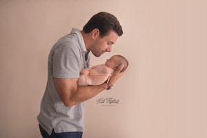 dad holding 8 day old baby girl