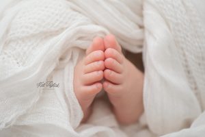 baby toes wrapped in soft white wrap
