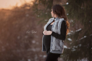 Expecting mom looking out over the hill winter maternity photo