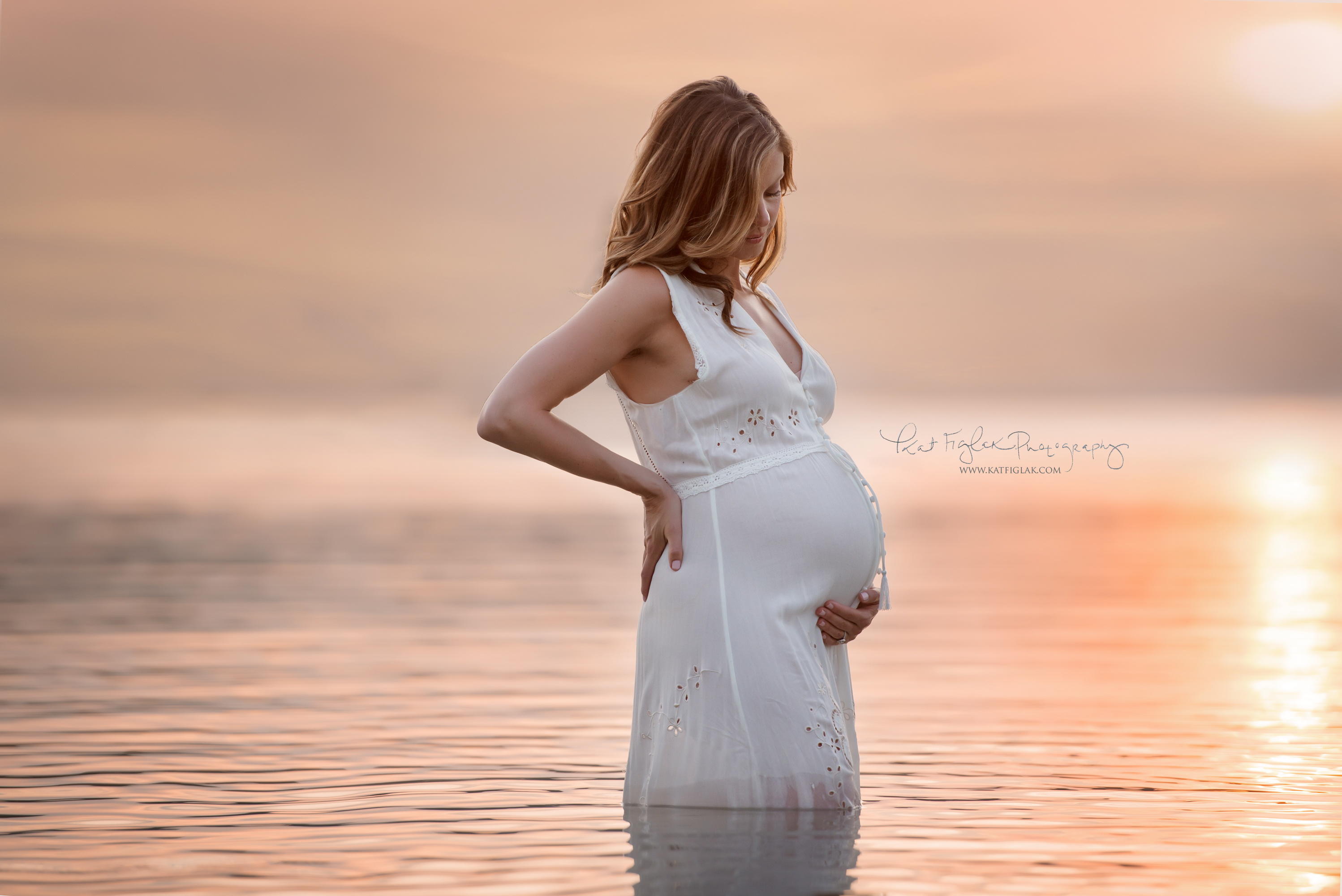beautiful pregnant mom in lake with stunning sunset