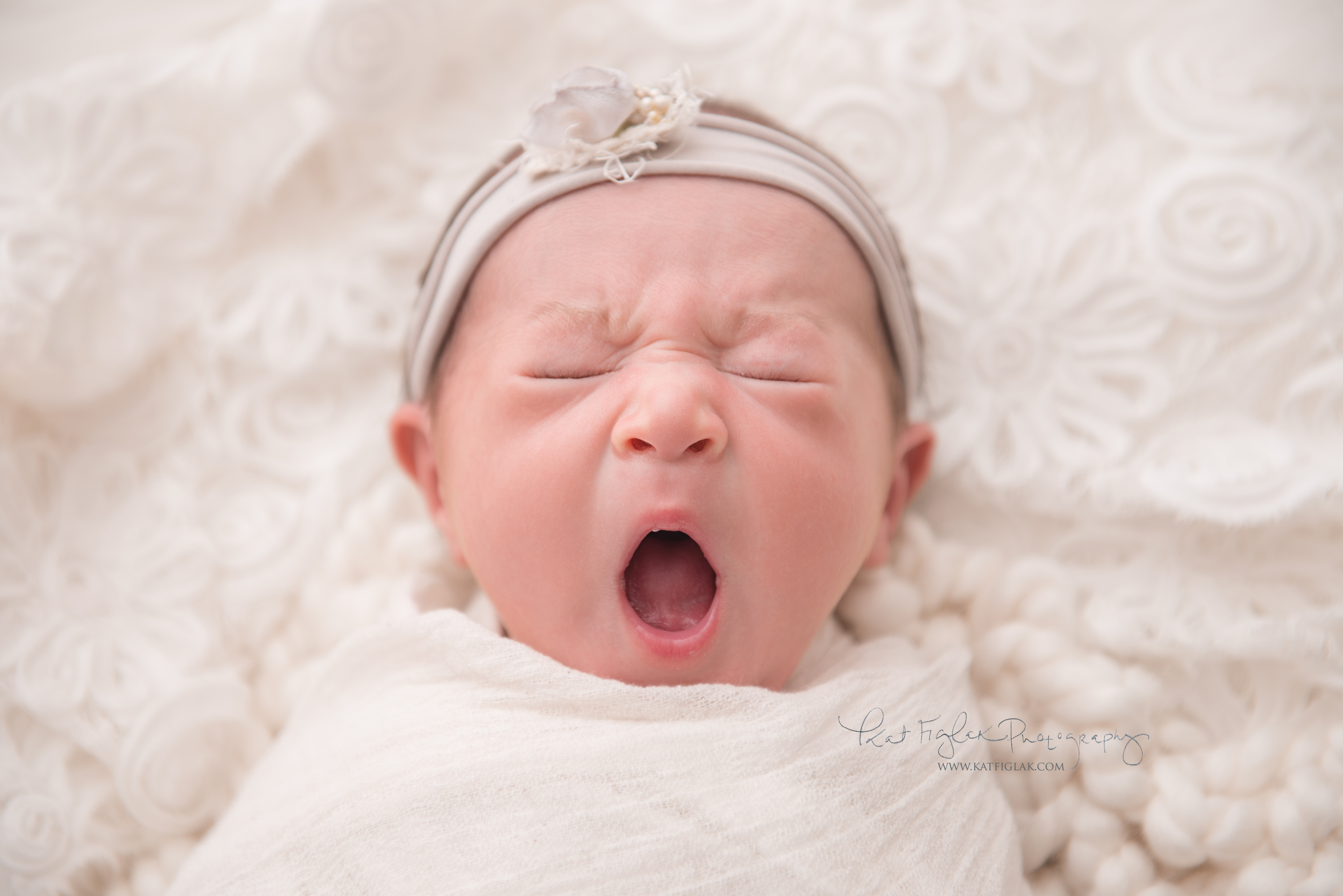 newborn baby girl yawning