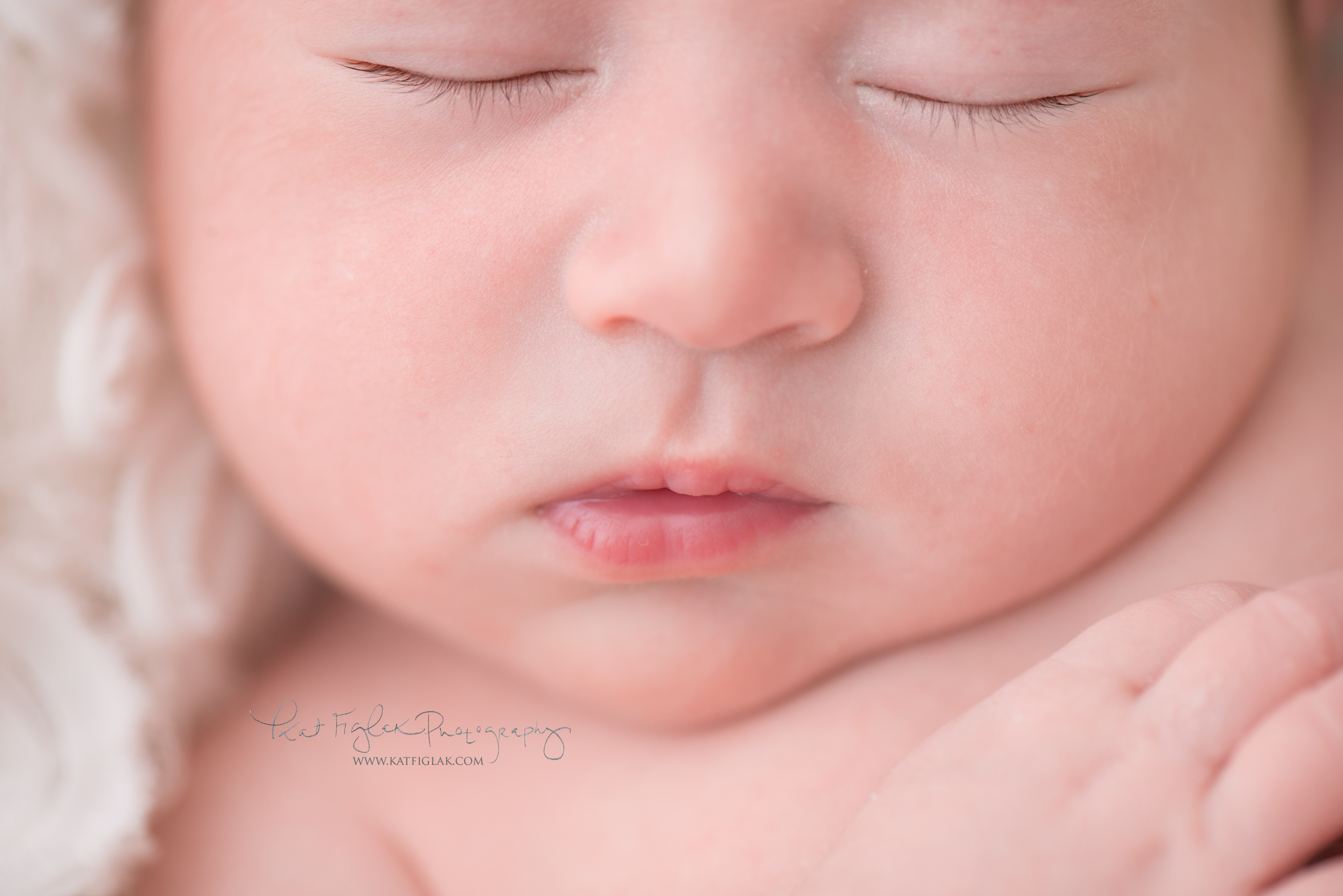 Detail shot of baby's lips nose and eyelashes