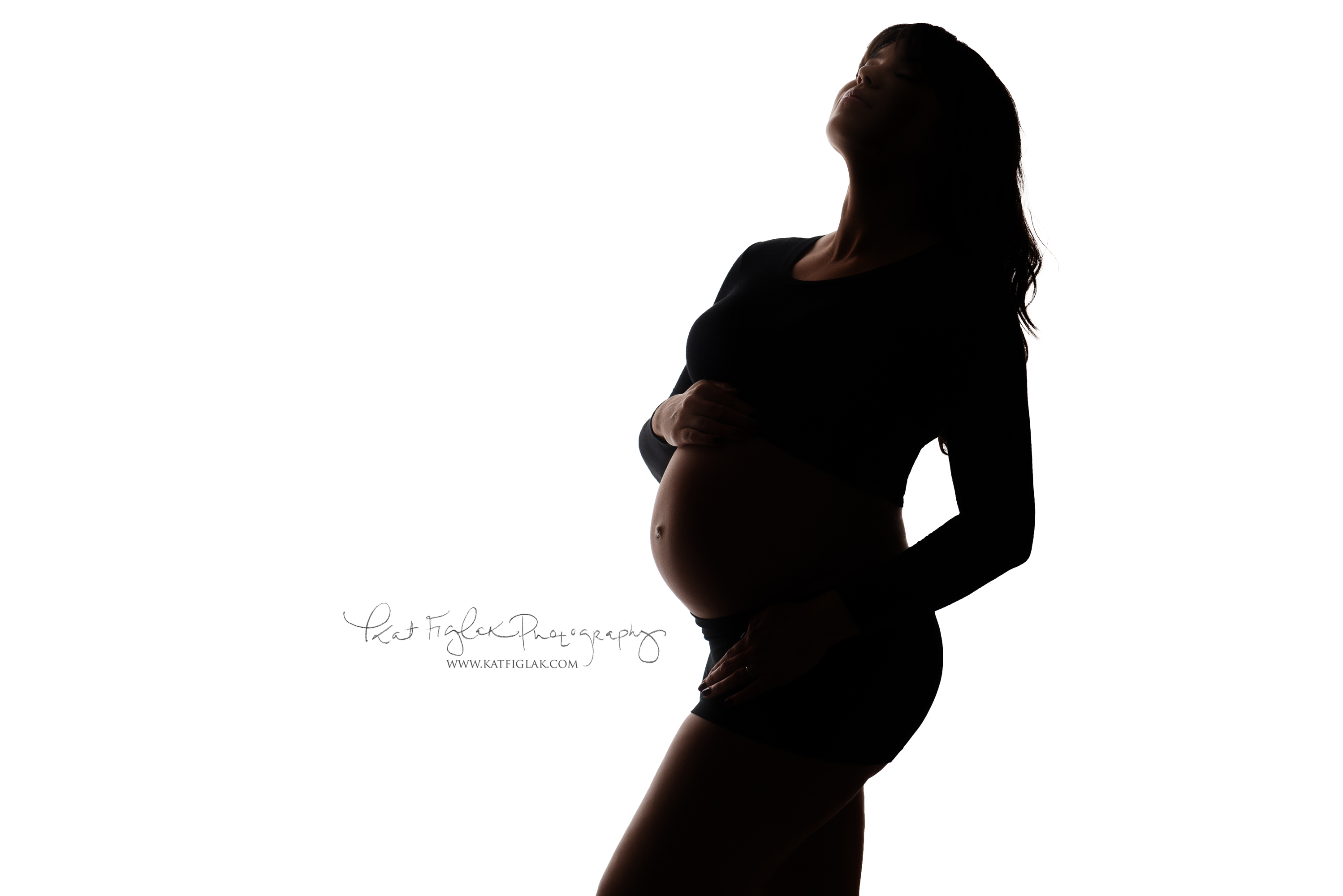 Backlit silhouette shot of a pregnant woman