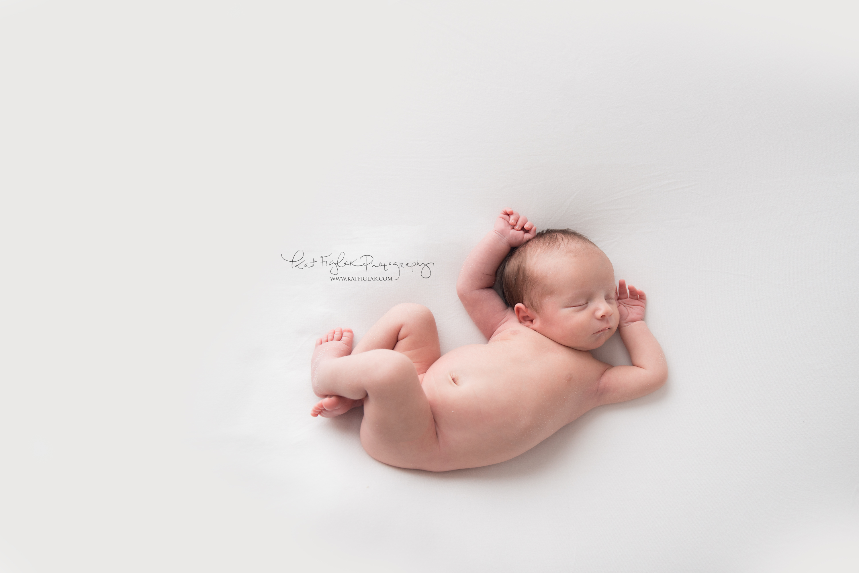baby boy sleeping in a natural newborn pose