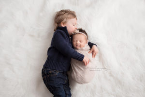 baby brother kissing his baby sister