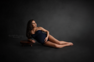pregnant mom wearing a navy bodysuit