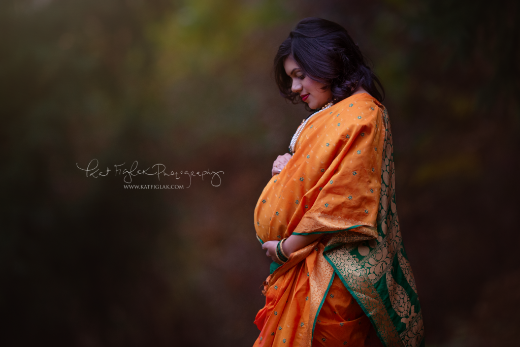 pregnant mom wearing a traditional indian dress bright vivid colors