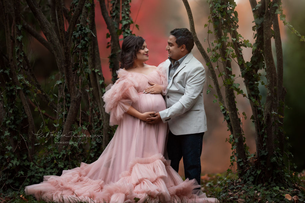 pregnant mom and husband mom wearing a beautiful pink tulle gown dad in gray suit jacket
