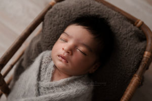 baby boy facial profile wrapped in gray wrap