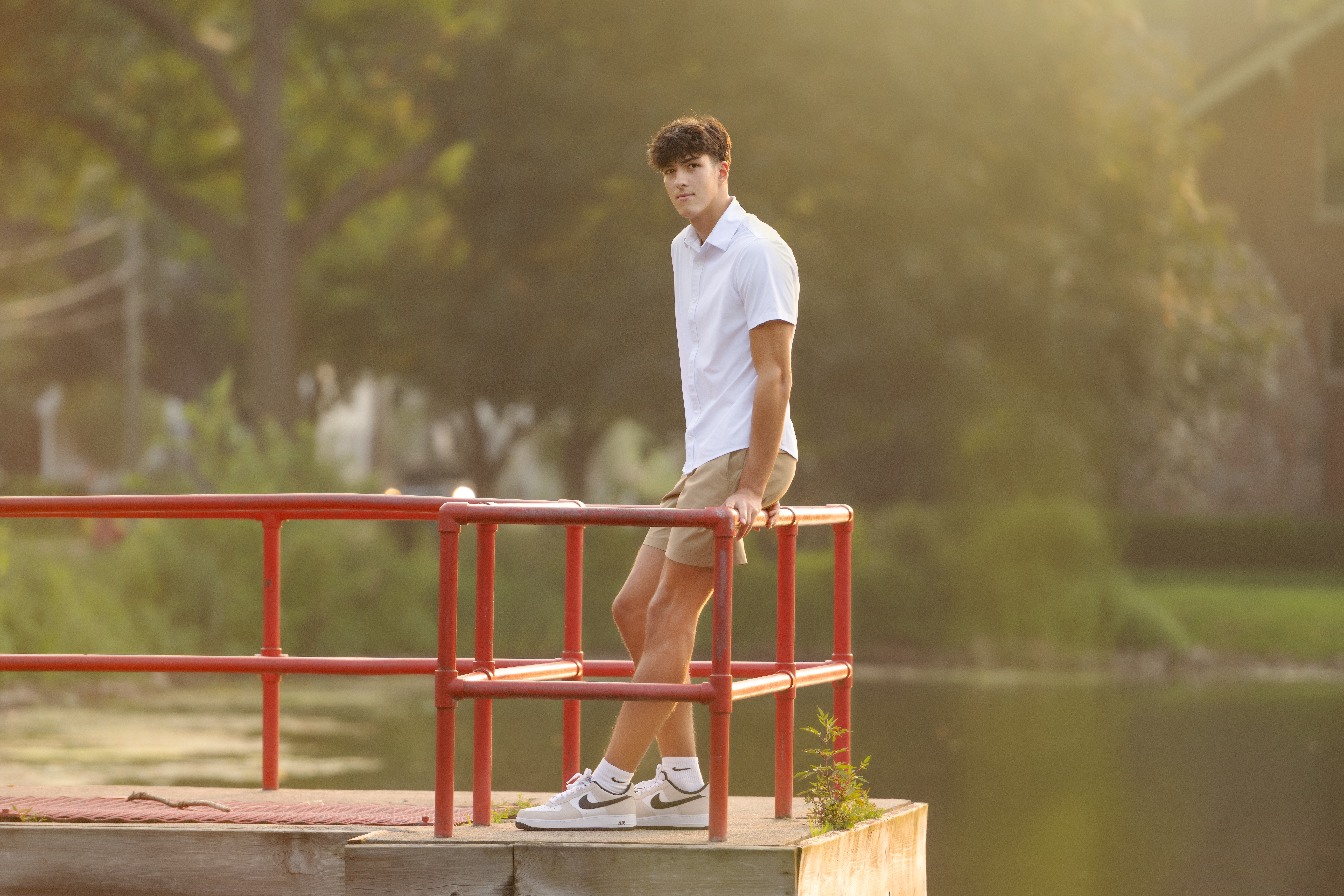 Flint Powers Catholic Senior boy standing on a bridge in downtown clarkston, MI