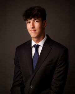 Senior Tyler wood from Flint Powers High School wearing a suit and royal blue tie